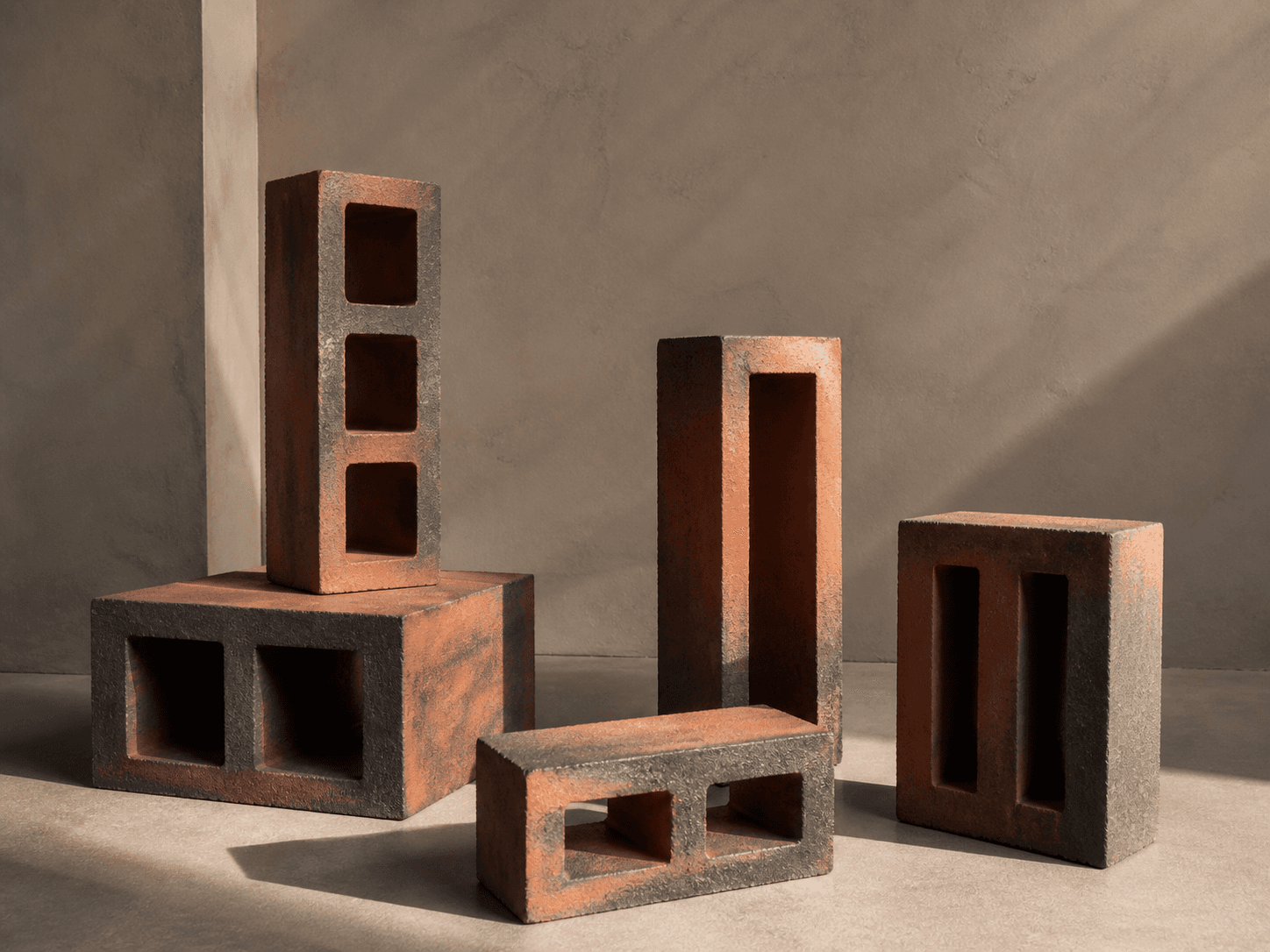 Sculptural arrangement of fired-clay hollow masonry units with visible cores